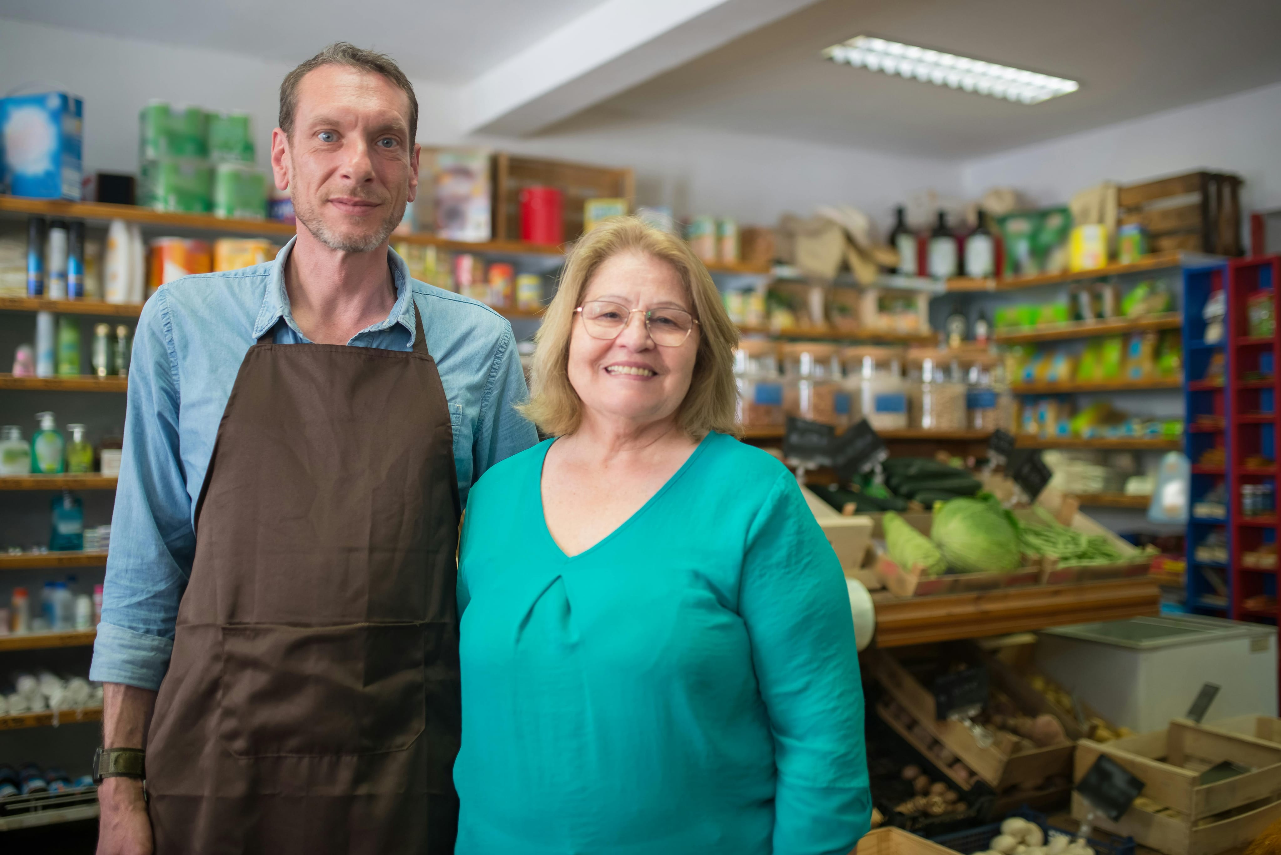 Market owners smiling in their shop